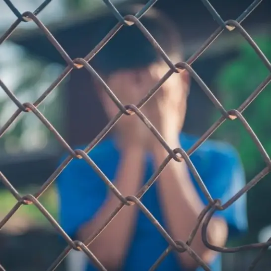 A kid behind the railing who is kidnapped